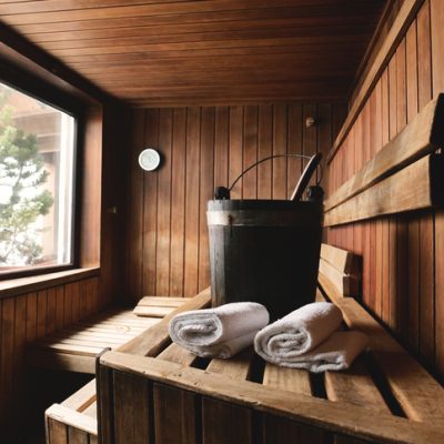 Location of a mountain wood sauna with a large window in which to relax. Concept of: interior design, relaxation, sauna, spa